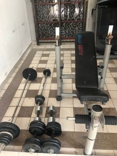 Gym bench with lots of dumbbells