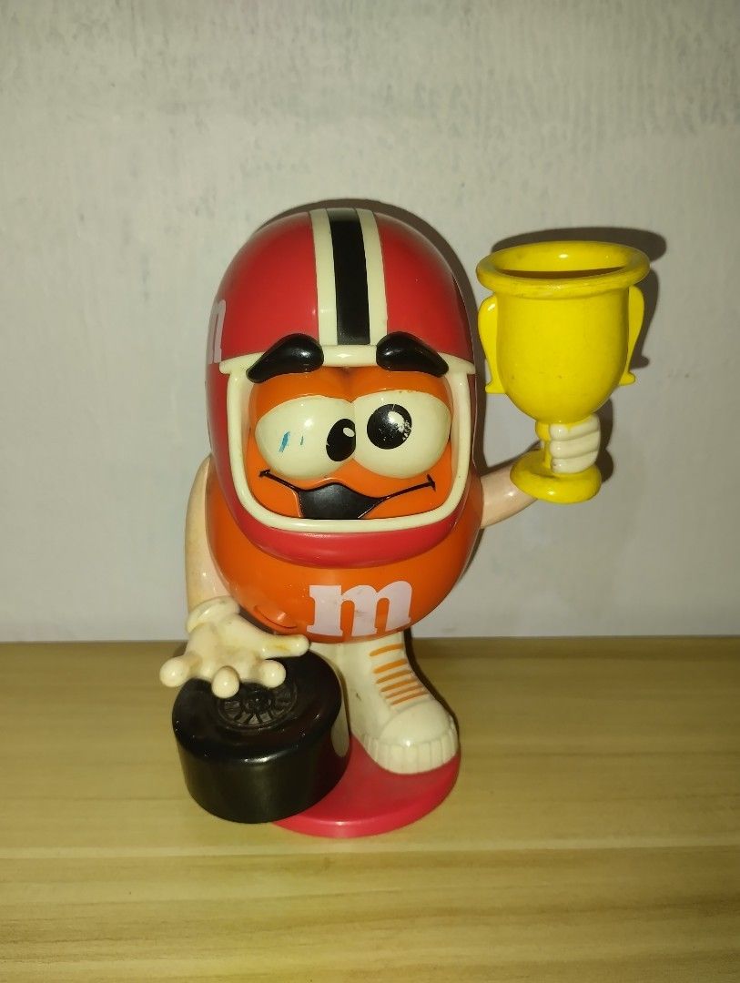 Orange M&M - 2005 Candy Dispenser (Category: Vintage Collectibles) located in Paranaque City. Submitted by nathan4you (Listing ID 1250234413, Image 1). Description: - There are a few dusts and removable marks - The figure is still in good shape - Classic and collectible M&M dispenser Feel free to message me :).