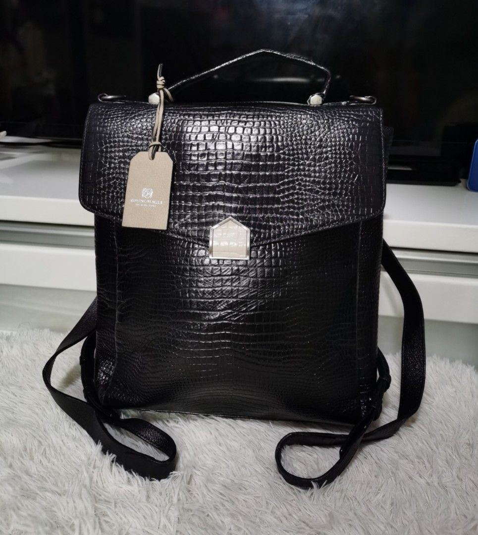 💯BRUNO MAGLI Backpack (Category: Backpacks) located in Cainta. Submitted by phengaying (Listing ID 1250432715, Image 1). Description: Original Bruno Magli Genuine Leather Backpack Medium Size | Re-colored from White to Black | Flaw/s: Small Leather Stain on the back flap closure.
