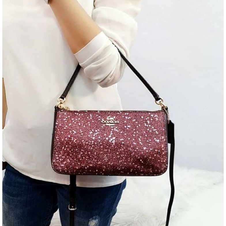 Coach top handle hotsell pouch with star glitter