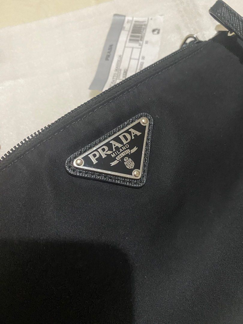 AUTHENTIC PRADA WRISLET (Category: Luxury Bags & Wallets) located in Cebu City. Submitted by kgs87 (Listing ID 1251064177, Image 3). Description: 100% authentic. Bought bnew, Not thrifted. Very good condition. Minor signs of use - last pic. Just the zipper since I sometimes change the strap to convert it to kili bag 😅 but really not noticeable unless you stare at it up close. 9/10 condition still. RFS - decluttering and I don’t really use it tha