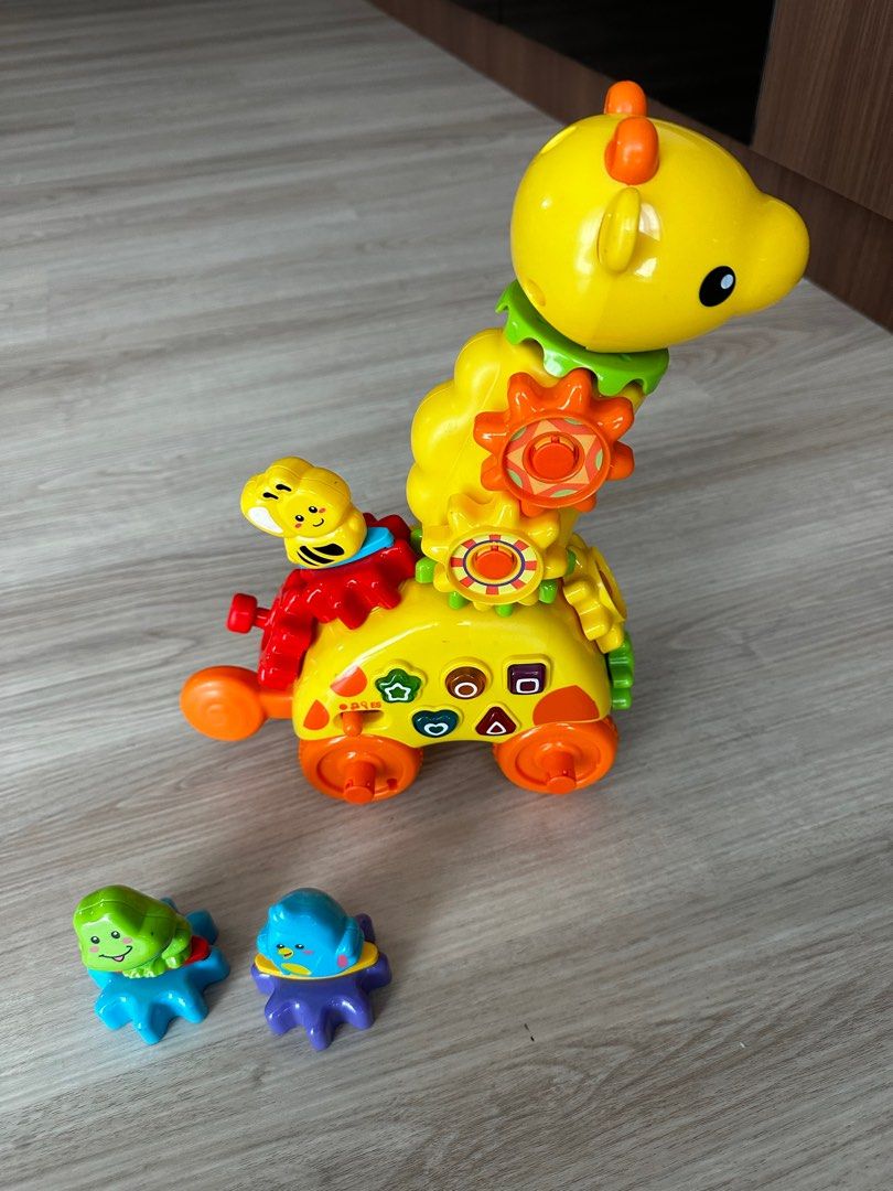 VTech Giraffe (Category: Educational & Learning Toys) located in Singapore. Submitted by tidusxtidus (Listing ID 1251017374, Image 1). Description: VTech Giraffe toy with animal gears. The sounds changes with different input of the animal gears. Teaches a variety of concepts..