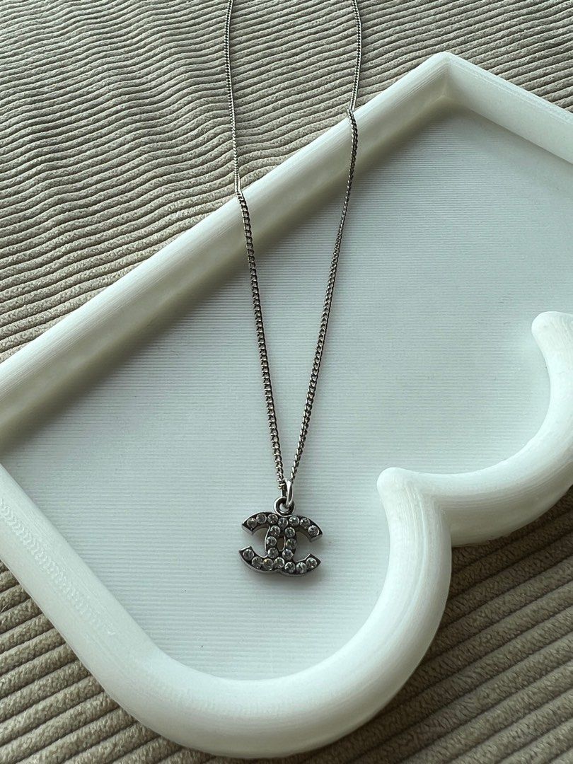 A Chanel necklace of silver-coloured metal, rhinestones, enamel