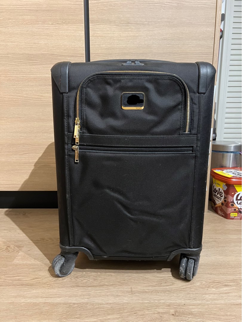Tumi black top and gold luggage