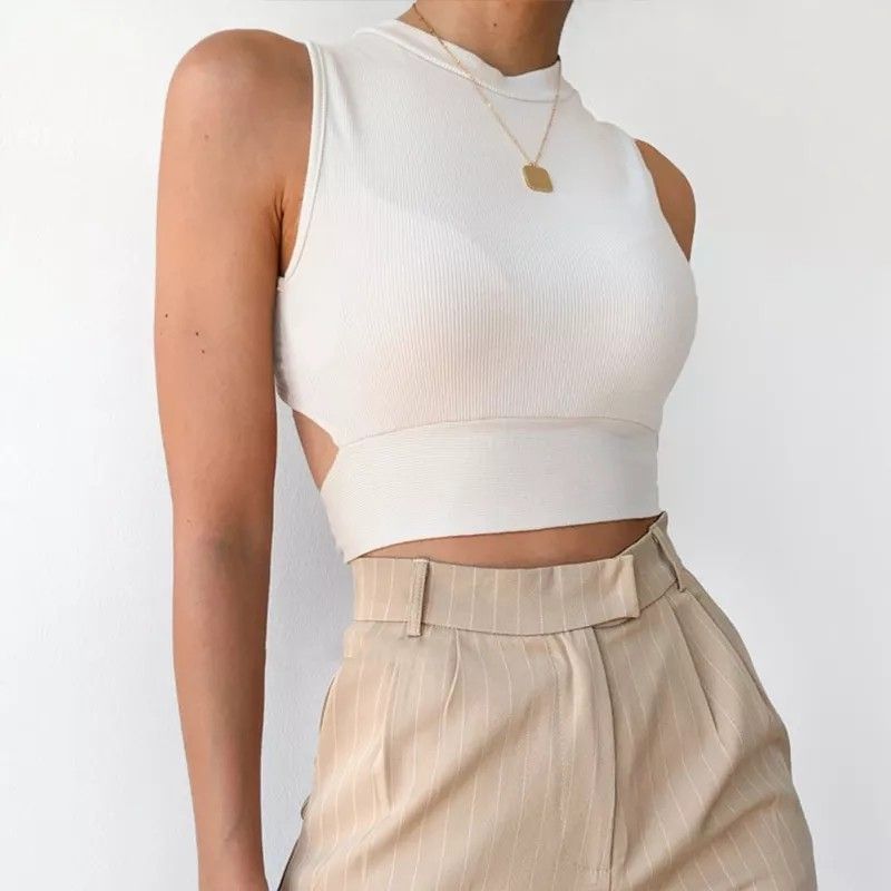 Cami Crop Top (Category: Sleeveless) located in Quezon City. Submitted by midnight.muse (Listing ID 1247271737, Image 1). Description: Cami Crop Top Sexy Open Tied Back Used: 2x only Color: White Knitted 8/10 Size: S-M.