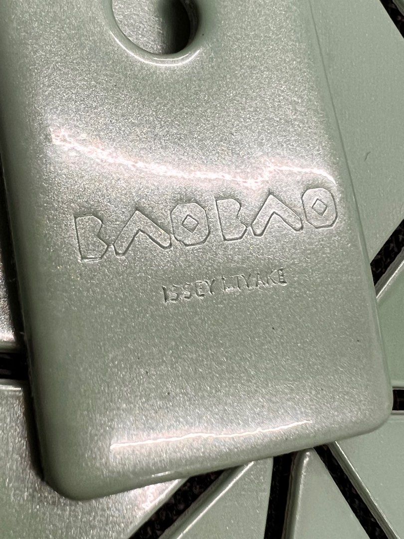 Authentic BaoBao Issey Miyake (Category: Luxury Bags & Wallets) located in Cagayan de Oro. Submitted by riggstuffs (Listing ID 1247376146, Image 3). Description: Guaranteed Authentic Bao Bao In metallic green in color Exterior material is in very good condition No missing triangle or cracks Interior material is clean with zipper pocket Rank SA in condition Disclaimer Riggstuffs is not associated wigg Ty the brand posted. All trademarks and copyri