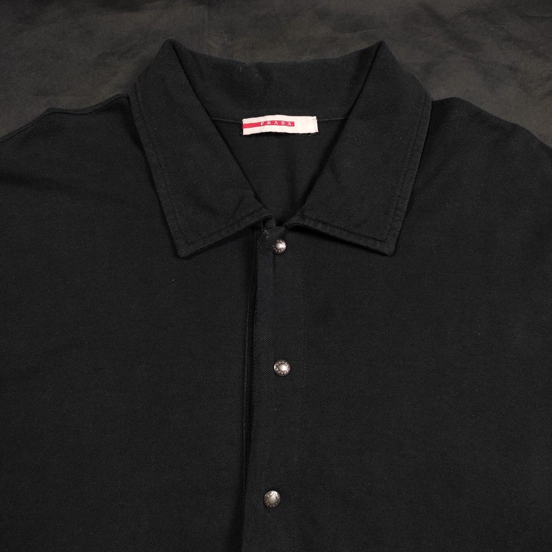 PRADA - red tab polo shirt (Category: Tshirts & Polo Shirts ) located in Quezon City. Submitted by cyborgph (Listing ID 1247554333, Image 3). Description: PRADA RED TAB POLO SHIRT xl IN GOOD CONDITION issue: pinhole front and back unnoticeable can send more photos if needed.