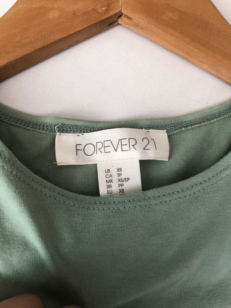 forever 21 sage green sleeveless top (Category: Sleeveless) located in Taguig. Submitted by unfeigned (Listing ID 1247862076, Image 1). Description: price is firm^^ has a very light discoloration in front (kindly refer to photos) .