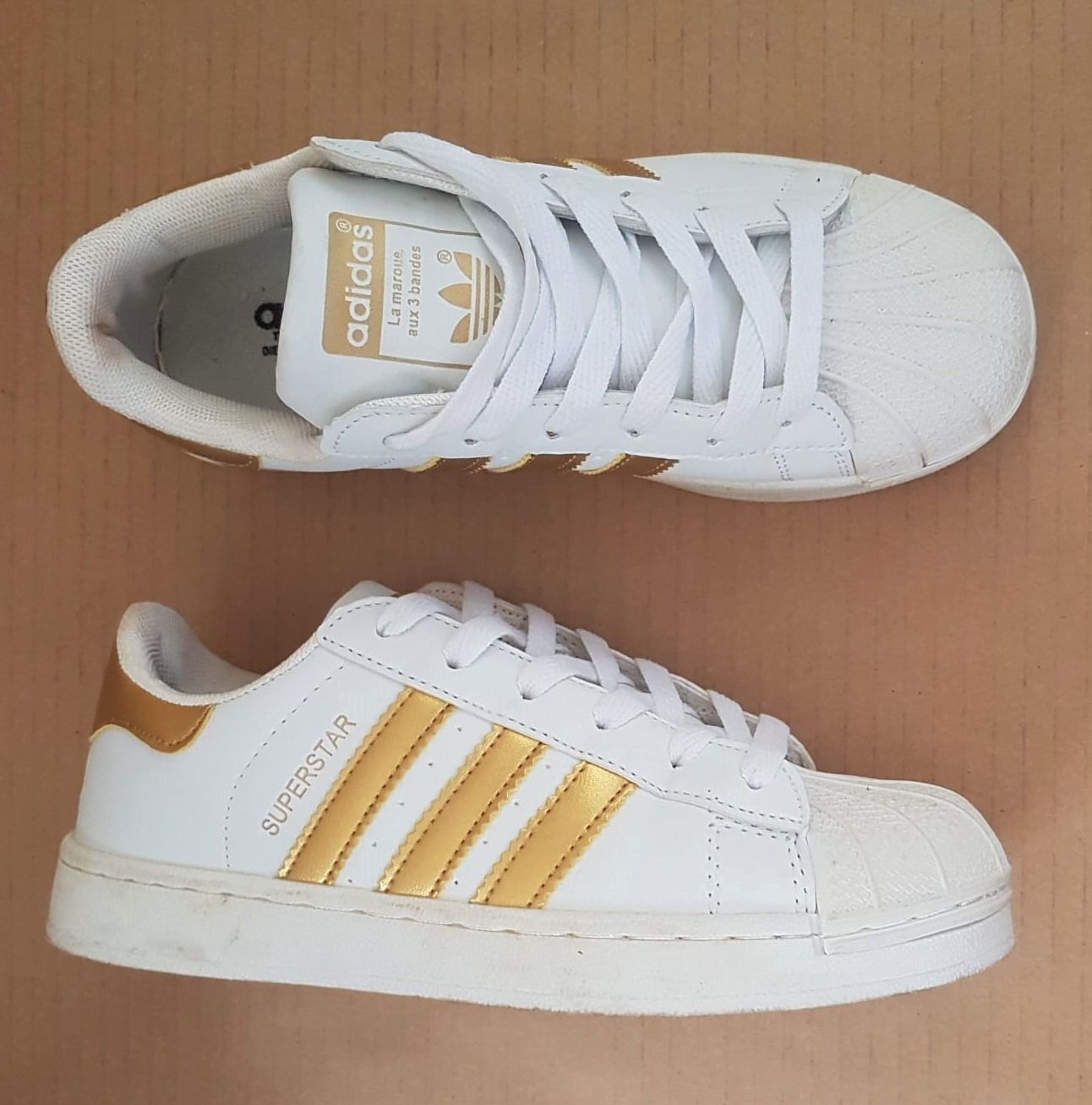 White sneakers with gold stripes sale