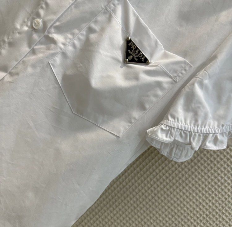 Prada poppline white ruffled elegant polo preorder (Category: Luxury Apparel) located in Angeles City. Submitted by luxury_district.korea (Listing ID 1254259282, Image 3). Description: Xs-xxl.