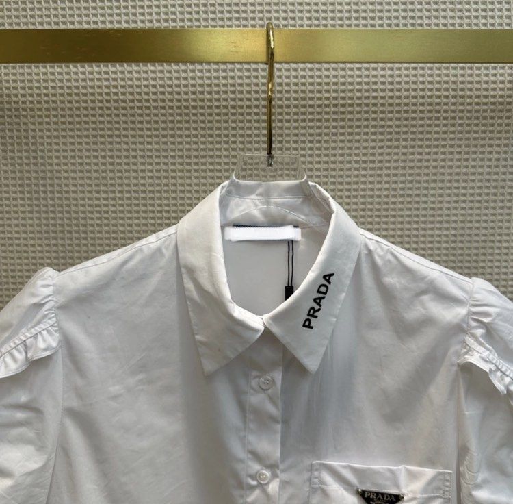 Prada poppline white ruffled elegant polo preorder (Category: Luxury Apparel) located in Angeles City. Submitted by luxury_district.korea (Listing ID 1254259282, Image 2). Description: Xs-xxl.