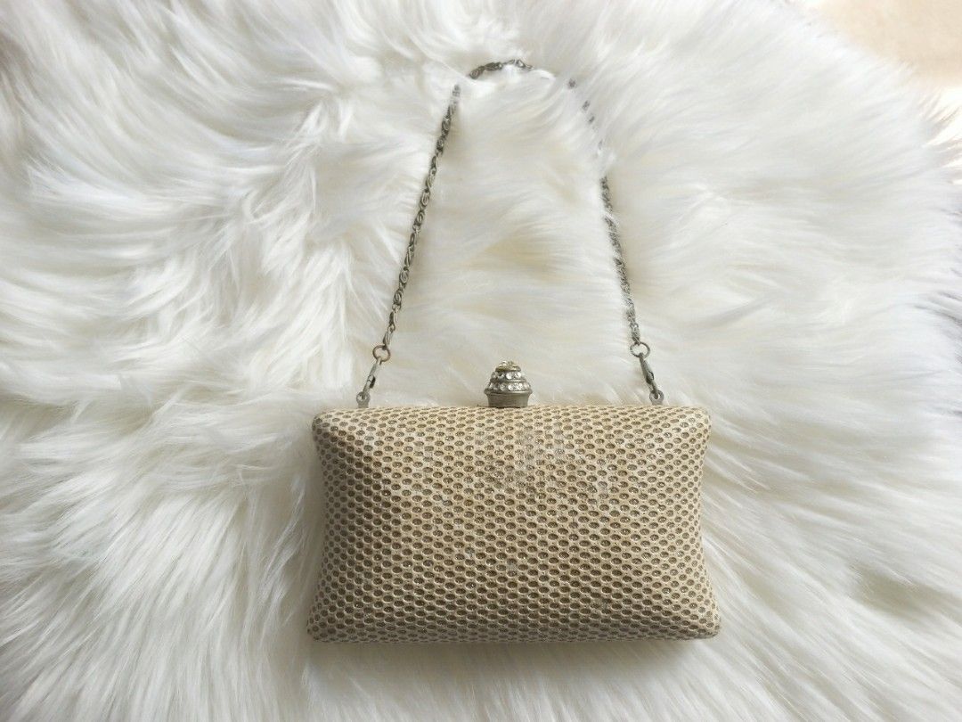 Delicate colored handbag shaped like a shell with pearls on Craiyon