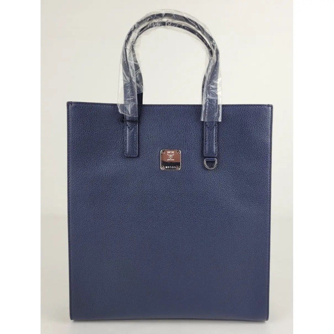 MCM Aren Tote Flora #declutterlux (Category: Bags & Wallets) located in Singapore. Submitted by KJO_Jewellery (Listing ID 1255336641, Image 3). Description: Made of Leather Dual Flat leather handles Magnetic closure Metal mcm logo plate Inside zipper pocket Cotton twill lining Measurement: 10.5L x11.75H x3.375Depth Comes w original tags dust bag and authenticity card.