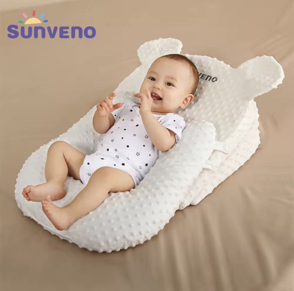 Baby sleeping on top u shaped pillow