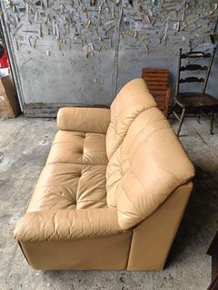 2-seater brown leather sofa, solid wood accent Genuine leather  54L x 33W x 14H seat height inches Sandalan height 32 inches In good condition