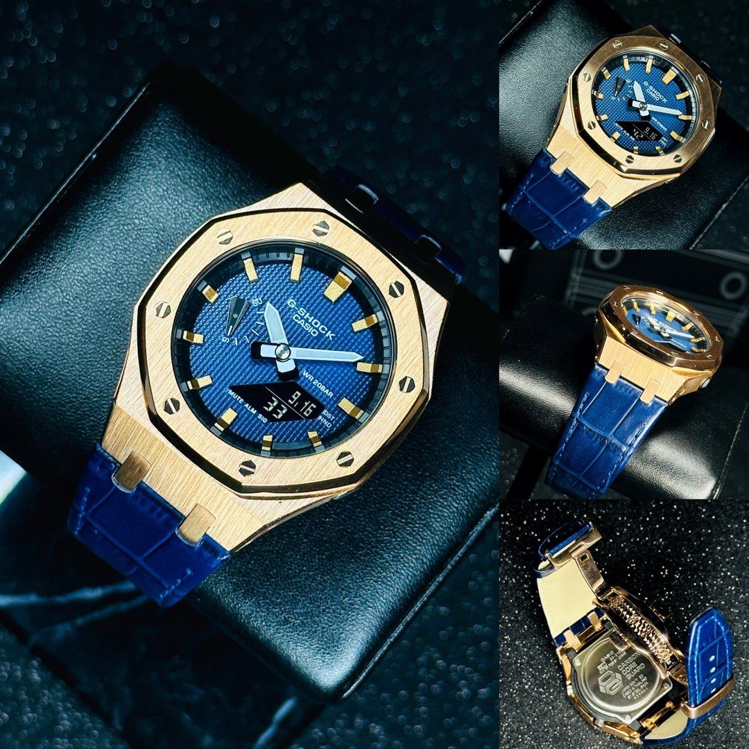 Latest CasiOak GA 2100 in Leather Strap Rose gold stainless steel bezel Blue Tapisserie Facedial and hand painted indexes Metal G Shock