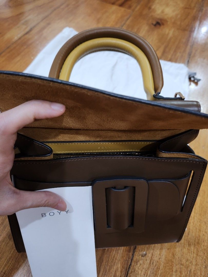 Boyy Karl double handle (Category: Luxury Bags & Wallets) located in Quezon City. Submitted by essinea (Listing ID 1210625015, Image 3). Description: PLEASE MAKE READING A HABIT. READ BELOW BEFORE CHATTING. Available. Boyy Karl 24 with 2 colour-blocked top handles and signature leather buckle Removable strap 100% calfskin; lining is calf suede front flap closure 9.4" x 11.8" x 5.1" In great condition and complete inclusions $1395 retail in moda o