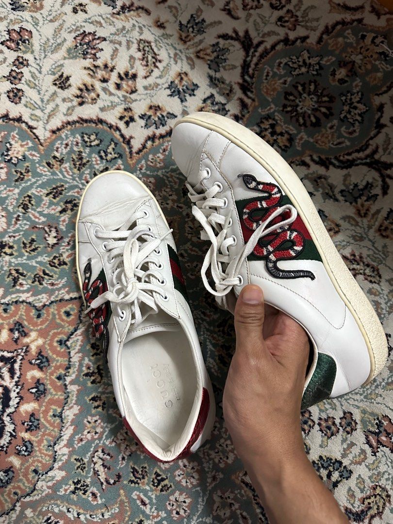 Gucci snake shoes on top feet
