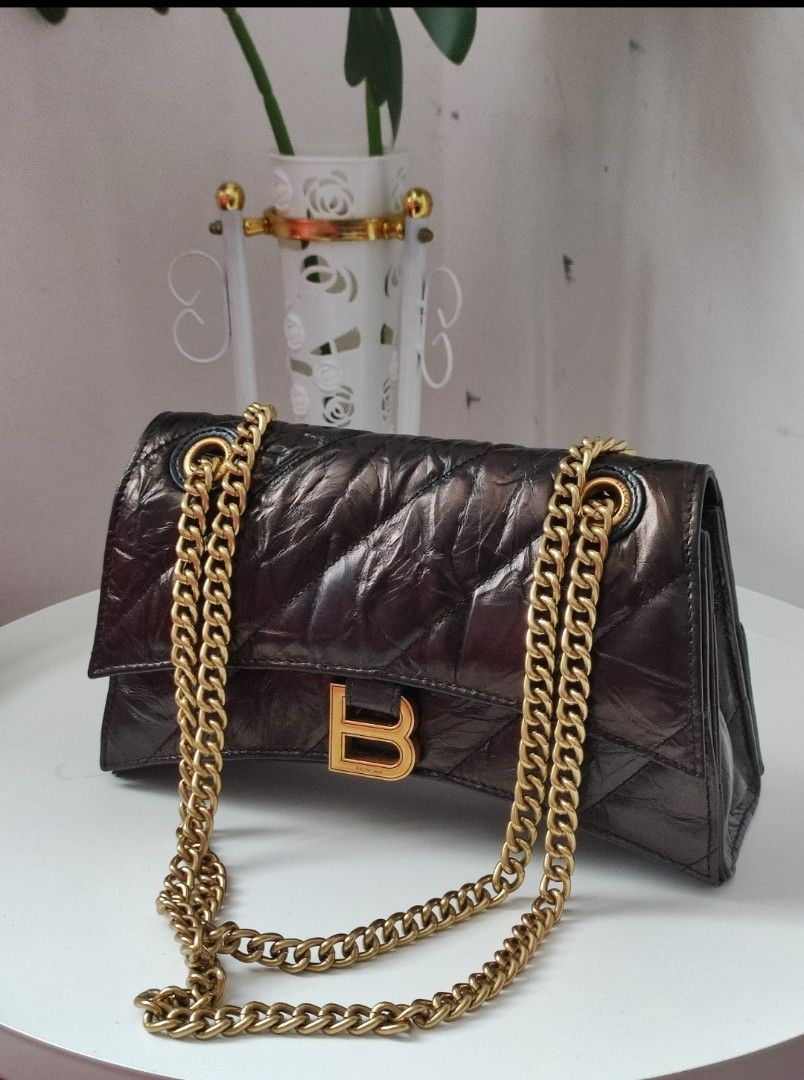 Balenciaga Crush Chain Bag (Category: Luxury Bags & Wallets) located in Santa Rosa. Submitted by sassycollection. (Listing ID 1255761237, Image 1). Description: A quilted bag is one of the easiest ways to add some texture and depth to your look and Balenciaga's Crush small chain bag does not disappoint. Designed with the iconic curvilinear base, this puffy silhouette is crafted from crushed calfskin with diagonal quilted stitching and finished wi