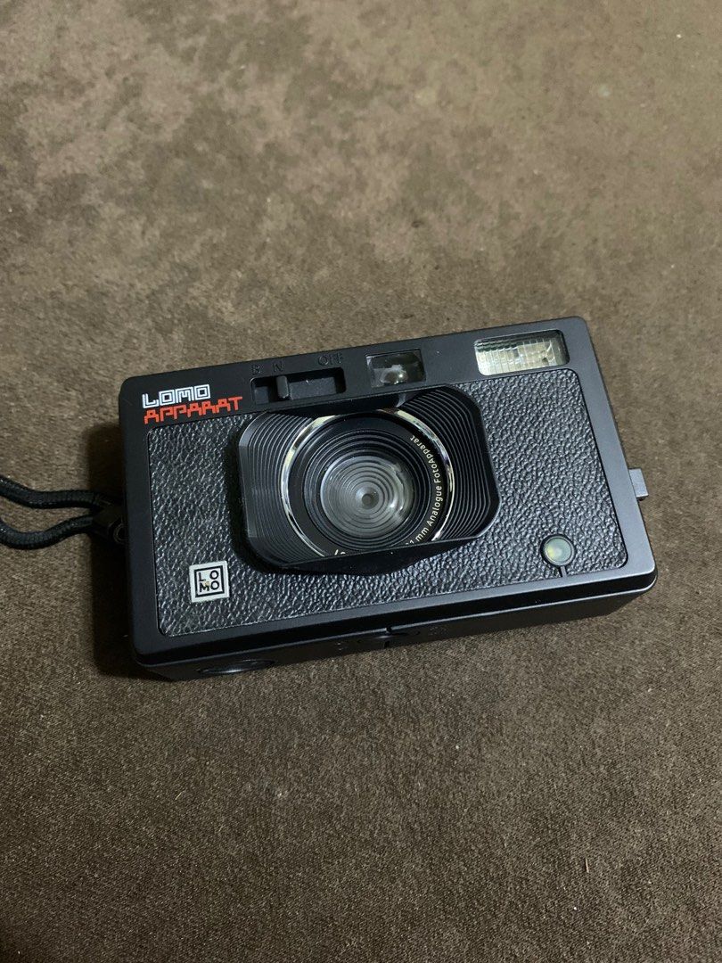 Lomo Apparat #Lomography (Category: Cameras) located in Manila. Submitted by coolstuffonlyyy (Listing ID 1255751385, Image 1). Description: w/ free unopened Agfa photo black & white film 400 ISO (36 shots) -No issues; barely used Film Format: 35 mm Focal Length: 21 mm Available Apertures: f10 Shutter Speed: 1/100 (N), Bulb (B) Flash: Built In Flash Available ISO Settings: No ISO Adjustment Multiple Exposure: Yes Tripod Mount: Yes Cable Release: N
