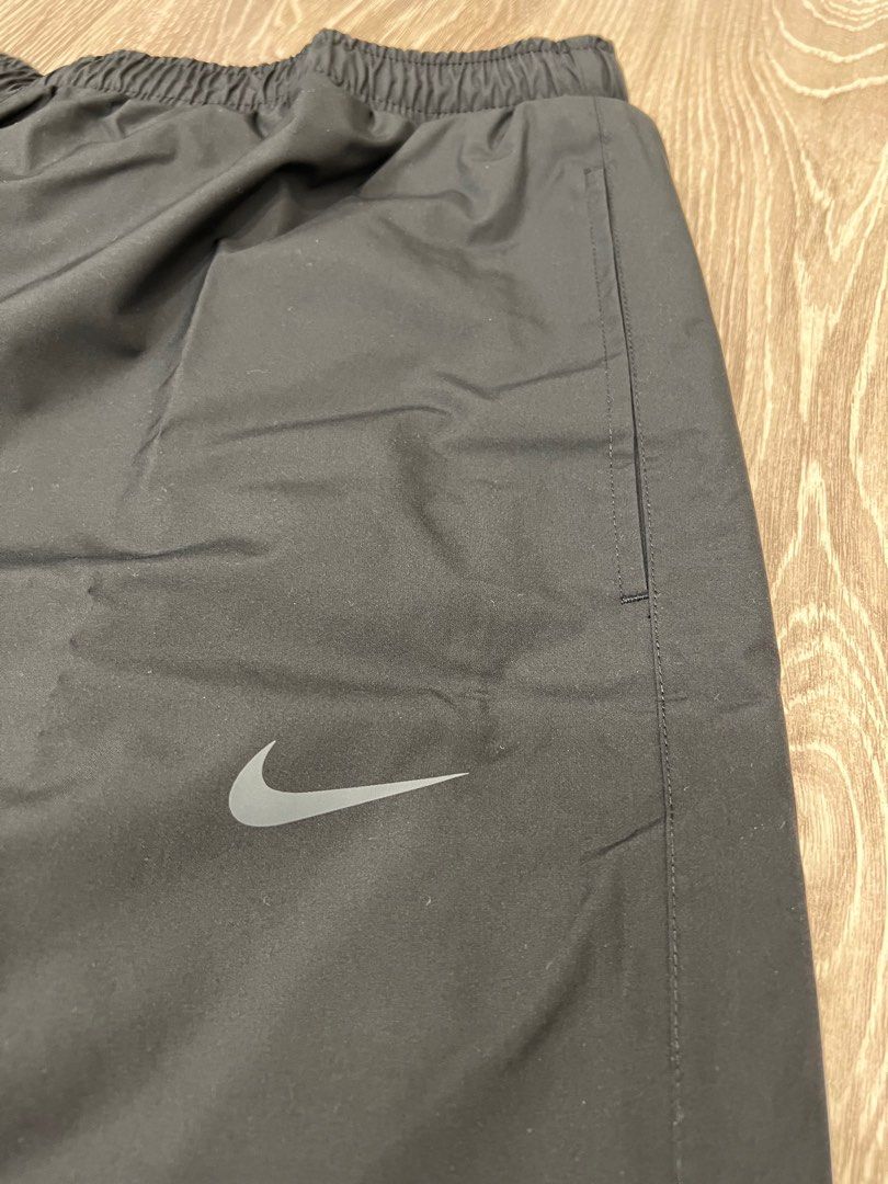 Nike track pants with zipper pockets on sale