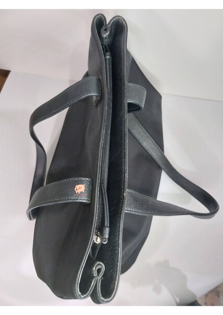 Preloved Bag | DKNY | Black Shoulder Bag (Category: Luxury Bags & Wallets) located in Mandaluyong City. Submitted by maruporks (Listing ID 1252579797, Image 3). Description: Mode of Payment: Gcash / Komo / Shoppee Pay Transfer Mode of Delivery: Grab and Lalamove (Only in the morning), or via J&T (Drops off during weekend) Brand: DKNY Color: Black Style: Shoulderbag only Material: Nylon and Leather Hardware: Silver Flaws: Minimal signs of use due 