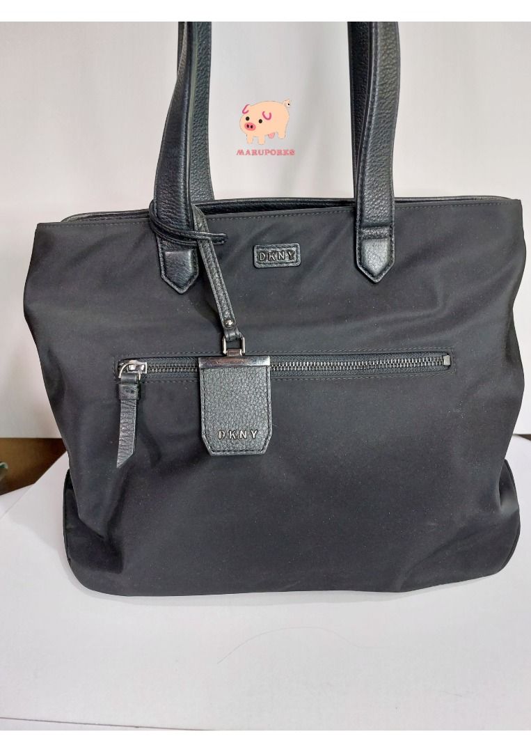 Preloved Bag | DKNY | Black Shoulder Bag (Category: Luxury Bags & Wallets) located in Mandaluyong City. Submitted by maruporks (Listing ID 1252579797, Image 1). Description: Mode of Payment: Gcash / Komo / Shoppee Pay Transfer Mode of Delivery: Grab and Lalamove (Only in the morning), or via J&T (Drops off during weekend) Brand: DKNY Color: Black Style: Shoulderbag only Material: Nylon and Leather Hardware: Silver Flaws: Minimal signs of use due 