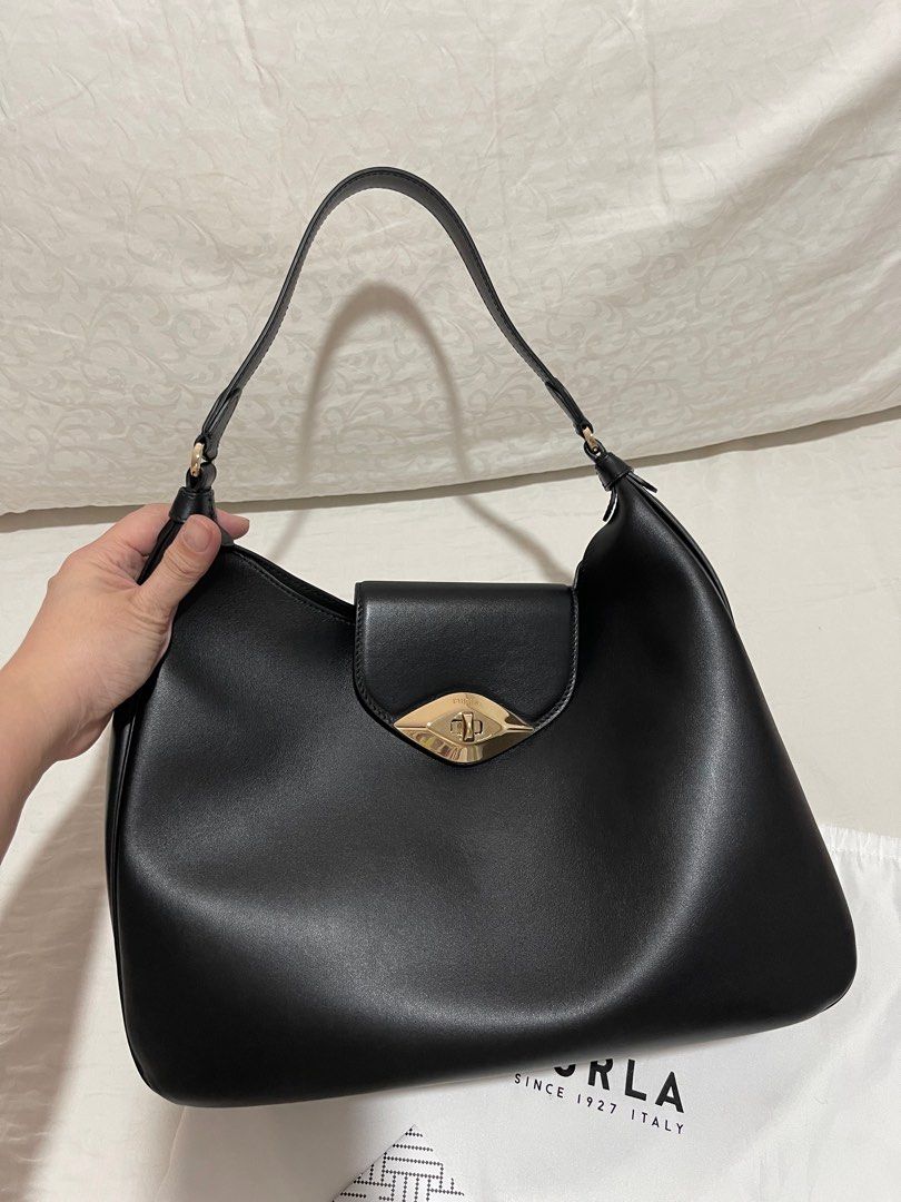 Furla Leather Hobo Bag (Category: Luxury Bags & Wallets) located in Caloocan City. Submitted by thejoyofshopping (Listing ID 1256122030, Image 3). Description: Black Leather with Gold Hardware Size: W13” x H11” x D5” Comes with Dustbag and card w/ free Generic Adjustable Strap *Used ONCE (good as new).