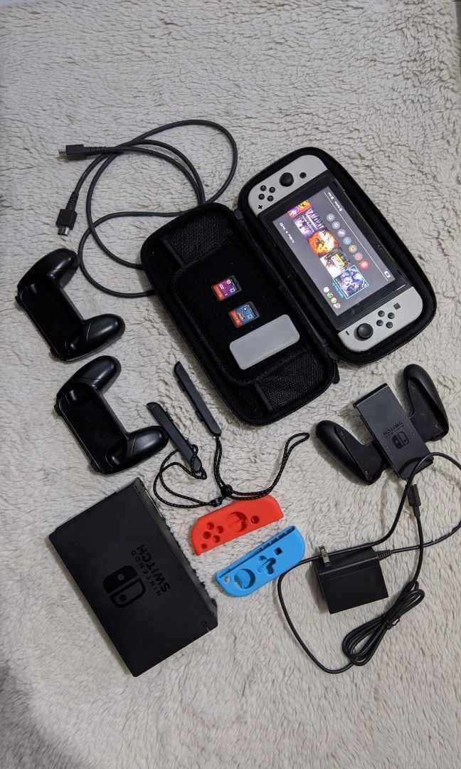 Nintendo Switch v2 with Freebies (Category: Nintendo) located in Malabon City. Submitted by mirajane55 (Listing ID 1256158461, Image 1). Description: Nintendo Switch v2 white joycons w/ freebies Inclusion: > 2 Physical Game Cartridges (Nba 2k23 and Mutant Football League) > Digital Games ( Saints Row 3, Saints Row 4, Red Faction Remarstered and Metro Last Light Redux) > 128 Samsung Evo SD Card > Joycon Grip > Individual Joycon Grip > HDMI cable >