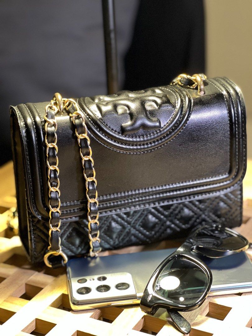 Tory Burch fleming quilted leather convertible NGA! (Category: Luxury Bags & Wallets) located in Makati City. Submitted by affordableeleganceemporium (Listing ID 1256649963, Image 1). Description: The Tory Burch Fleming Quilted Leather Convertible Shoulder Bag (NGA) is a luxurious and versatile accessory that embodies the brand’s timeless elegance and craftsmanship. Here’s what makes it stand out: 1. **Quilted Leather:** The bag features exquisit