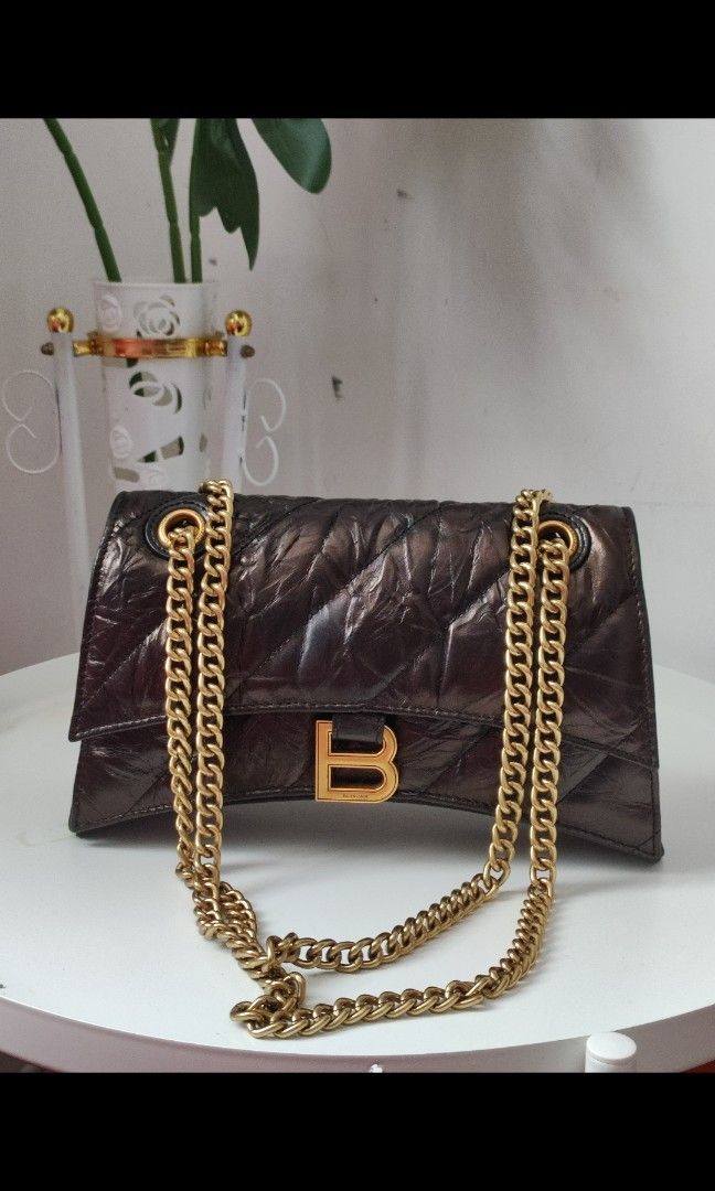 Balenciaga Crush Chain Bag (Category: Luxury Bags & Wallets) located in Santa Rosa. Submitted by sassycollection. (Listing ID 1255761237, Image 2). Description: A quilted bag is one of the easiest ways to add some texture and depth to your look and Balenciaga's Crush small chain bag does not disappoint. Designed with the iconic curvilinear base, this puffy silhouette is crafted from crushed calfskin with diagonal quilted stitching and finished wi