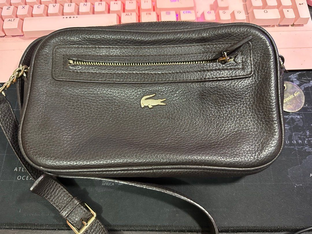Lacoste Camera Bag (Category: Luxury Bags & Wallets) located in Binangonan. Submitted by joizeeful (Listing ID 1256821969, Image 1). Description: Vintage Genuine leather No major flaw Signs of usage Very presentable and elegant Chip off leather on the inner part.
