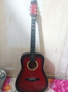 Acoustic guitar with bag, capo and strap