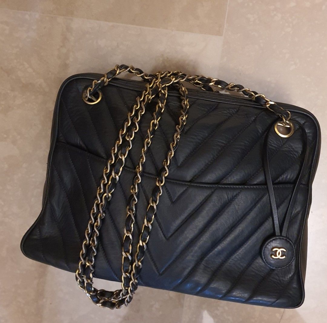 CHANEL CAMERA VINTAGE CHEVRON BAG, with top zip closure with charm pull,  one front pocket with CC turn lock closure, gold tone hardware and strap,  leather lining, authenticity card, c. 1991-1994, with