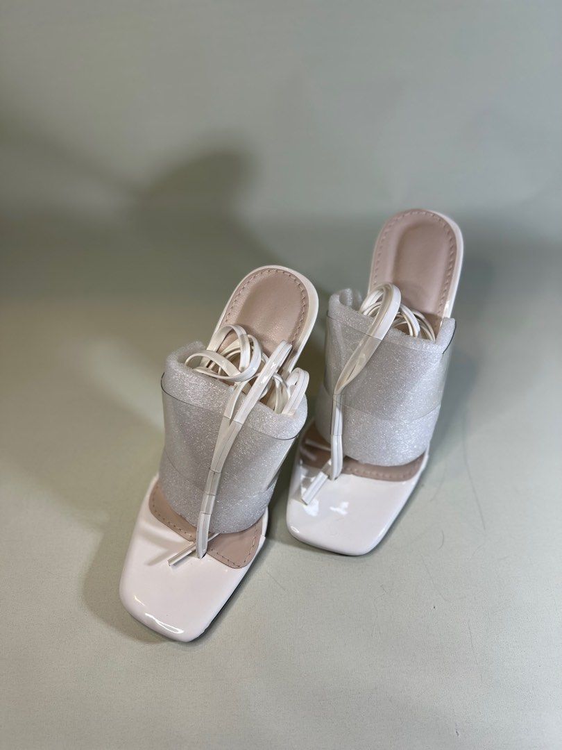 White Tie Leg Heeled Thong Sandals (Category: Heels) located in Paranaque City. Submitted by donnavlrn_ (Listing ID 1252785395, Image 1). Description: Color: White Type: Thong Sandals Heels: Sculptural Heels Heel Height: 10cm / 3.9inch Upper Material: PVC Lining Material: PVC Insole Material: PU Leather Outsole Material: Rubber SKU: sx2112075546476875 Item id: 8349262 Size: EU 36 / UK3 / US 5 New/never been worn outside the house Bought these for