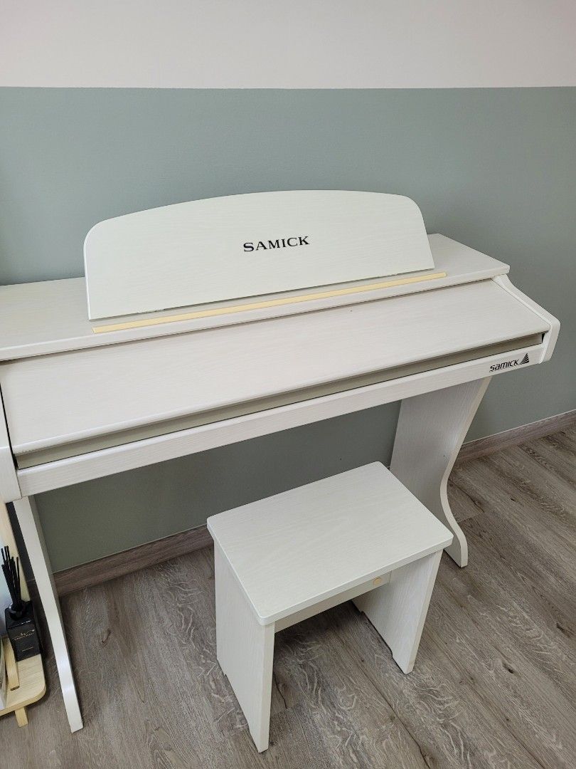 A cute white Samick piano