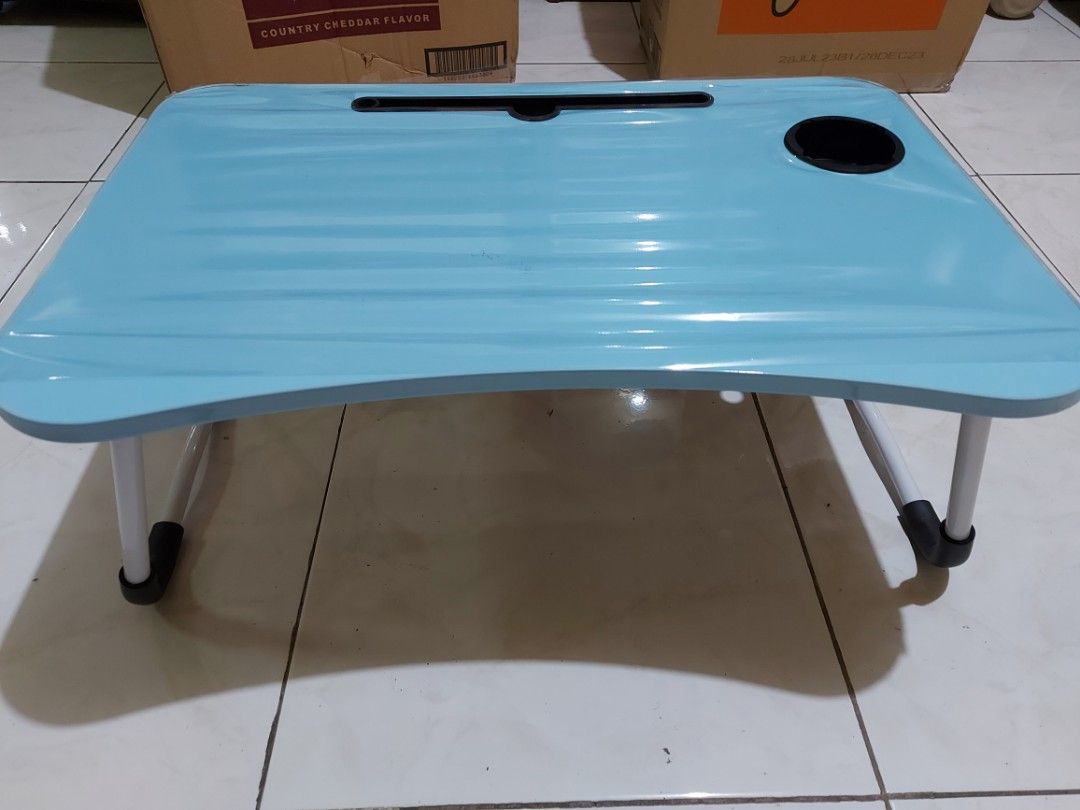 Foldable Laptop Wooden Table (Category: Tables & Sets) located in Makati City. Submitted by berniebones (Listing ID 1253036049, Image 3). Description: Foldable Laptop Wooden Table Dimensions: 60(L)x40(W)x29cm(H); 12mm thick table Color: Blue Brand new. Never used. No issues. RFS: Not needed anymore..