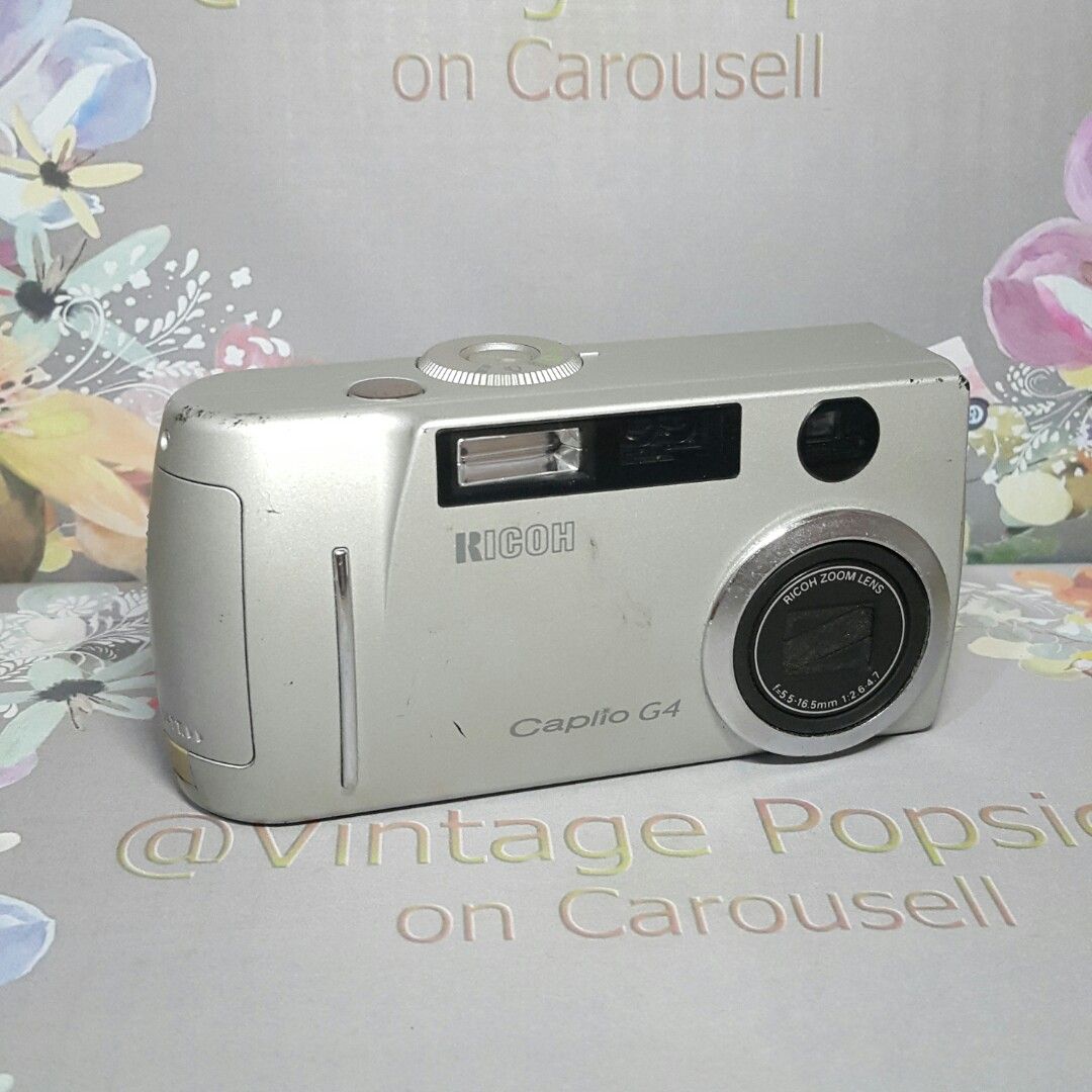 Rare Ricoh Caplio G4 Tested Working (Category: Cameras) located in Paranaque City. Submitted by vintagepopsicle (Listing ID 1253691530, Image 1). Description: Achieve the look of Old Vintage Vibes photos with this rare Ricoh Caplio G4 Digicam. ♡ Camera can take photo and video ♡ Tested including a working flash ♡ Optical Viewfinder to shoot in the sun or super bright areas where you can't see the LCD. ♡ High Sensitivity and other nice Scene modes