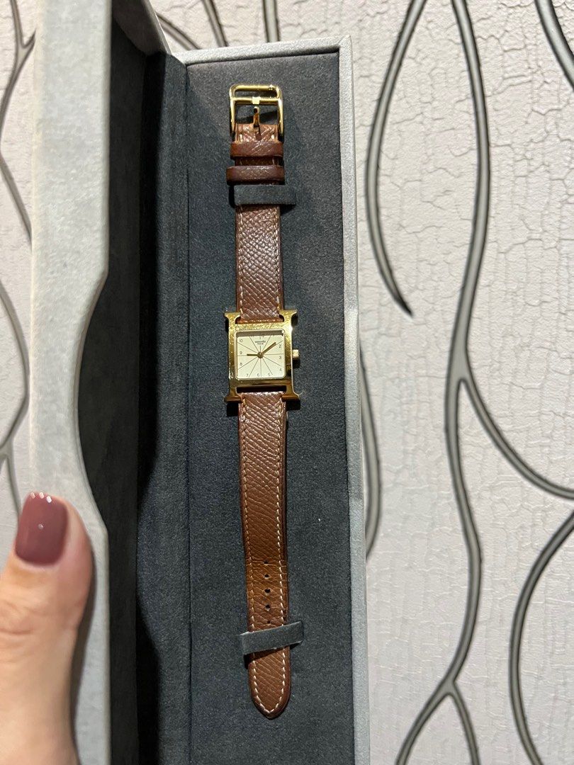 Hermes Heure Watch (Category: Luxury Watches) located in Pasig City. Submitted by ivydeborja (Listing ID 1253752436, Image 2). Description: Elegantly in gold frame and tan leather strap, Hairline scratches and natural darkening of the leather strap’s inner part (never seen of course when worn). Comes with a box, bought from a trusted friend early this year. This piece is slightly negotiable (pls see RFS to appreciate why 👇). It’s most ideal to M