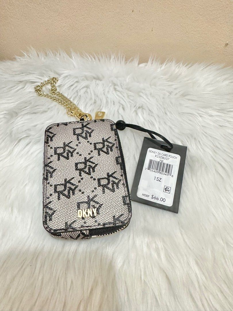 Original DKNY Sidney Zip Around Card Pouch (Category: Wallets & Card holders) located in Las Pinas. Submitted by anasonlineshophtplaspinas (Listing ID 1275663025, Image 2). Description: Original DKNY Sidney Zip Around Card Pouch Dimenstions: 4.25” H, 2.75” L, .75” W Zipper closure DKNY logo at front Removable chain 100% PVC with leather trim Origin: Imported.