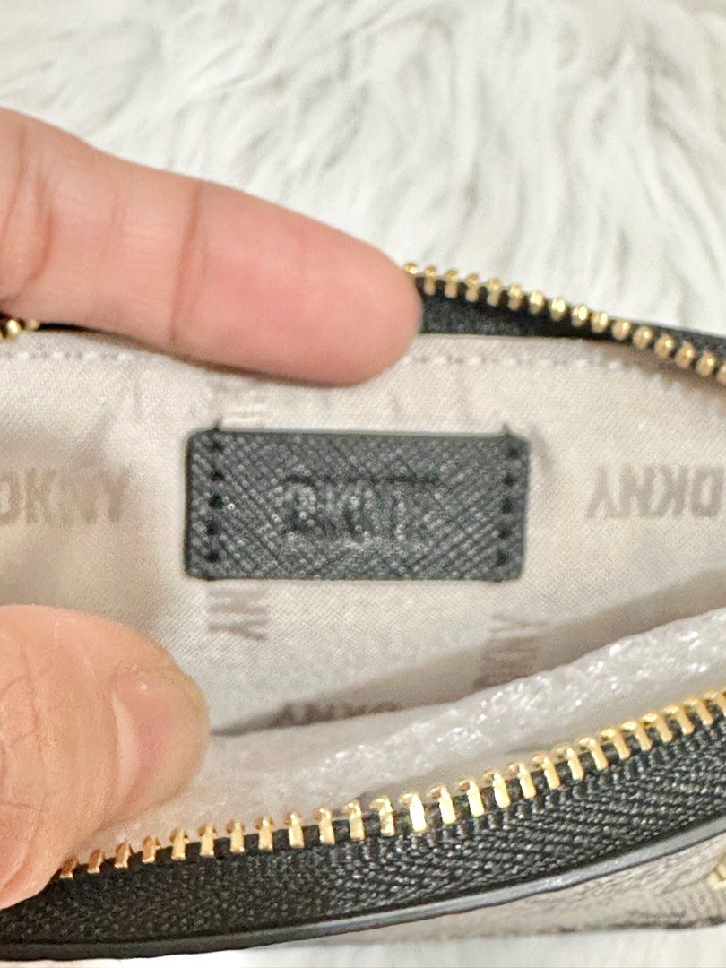Original DKNY Sidney Zip Around Card Pouch (Category: Wallets & Card holders) located in Las Pinas. Submitted by anasonlineshophtplaspinas (Listing ID 1275663025, Image 3). Description: Original DKNY Sidney Zip Around Card Pouch Dimenstions: 4.25” H, 2.75” L, .75” W Zipper closure DKNY logo at front Removable chain 100% PVC with leather trim Origin: Imported.