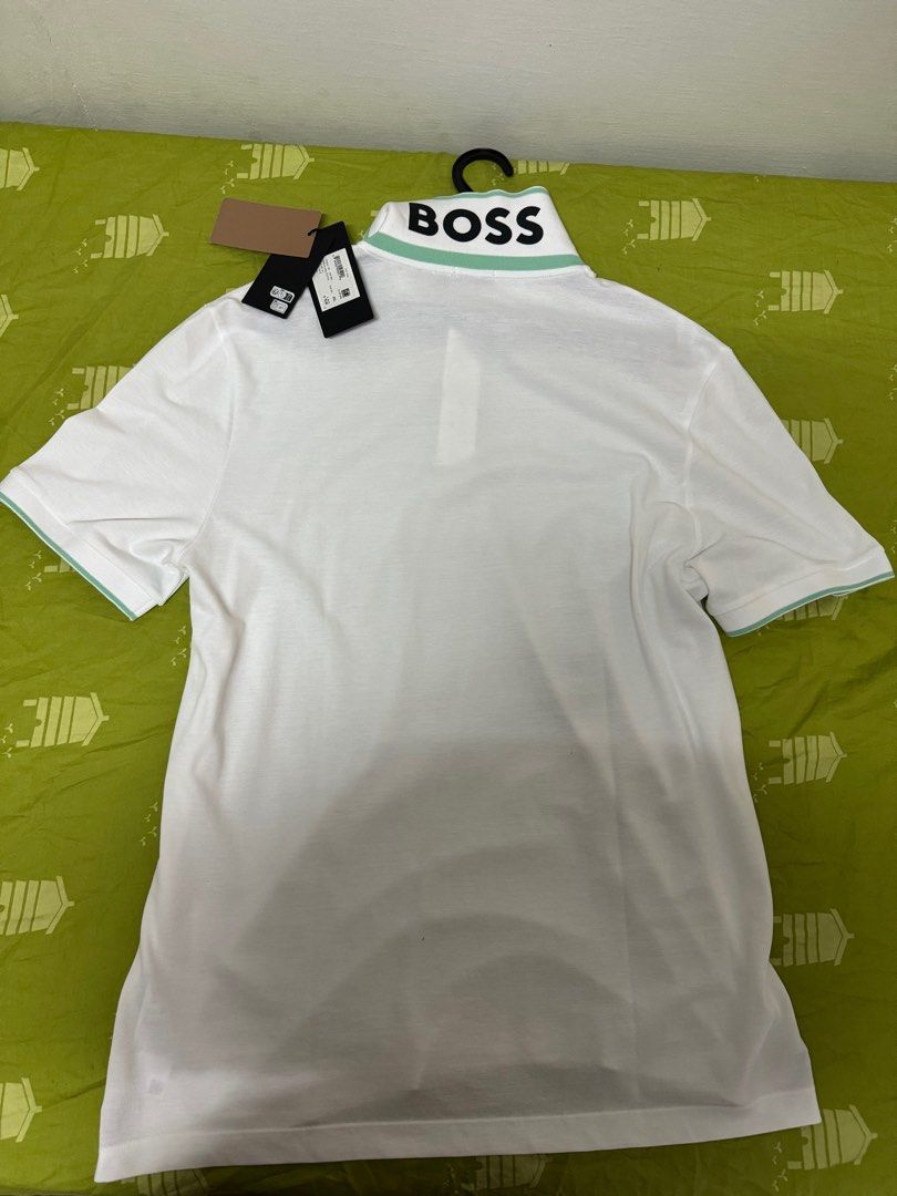Boss White Polo Shirt (Category: Tshirts & Polo Shirts ) located in Manila. Submitted by invinoveritas.670 (Listing ID 1278541209, Image 2). Description: Boss White Polo Shirt XL on tag but can fit XXL Issue: May stain na strike dun right side, nadumihan nung pinapack. Pero matatangal naman po yan pag nilabhan. Slightly negotiable. .