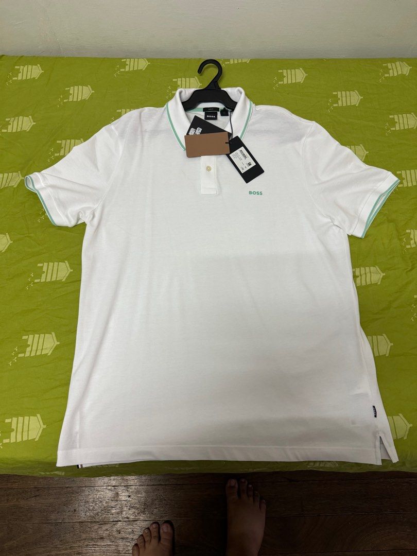 Boss White Polo Shirt (Category: Tshirts & Polo Shirts ) located in Manila. Submitted by invinoveritas.670 (Listing ID 1278541209, Image 1). Description: Boss White Polo Shirt XL on tag but can fit XXL Issue: May stain na strike dun right side, nadumihan nung pinapack. Pero matatangal naman po yan pag nilabhan. Slightly negotiable. .