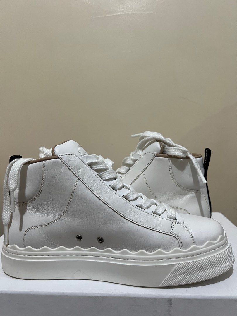 Authentic Chloé Lauren Leather High Top Sneaker (Category: Sneakers & Footwear) located in Makati City. Submitted by loriz_mar (Listing ID 1278788400, Image 1). Description: Sneaker heel height: flat - Upper: calfskin - Sole: rubber - Lining: sheepskin & goatskin Fit true to size, Italian sizing 35/22.5cm - Leather sneaker - Lace-up Colour: white.