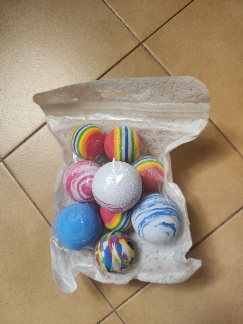 Cat deals dog balls