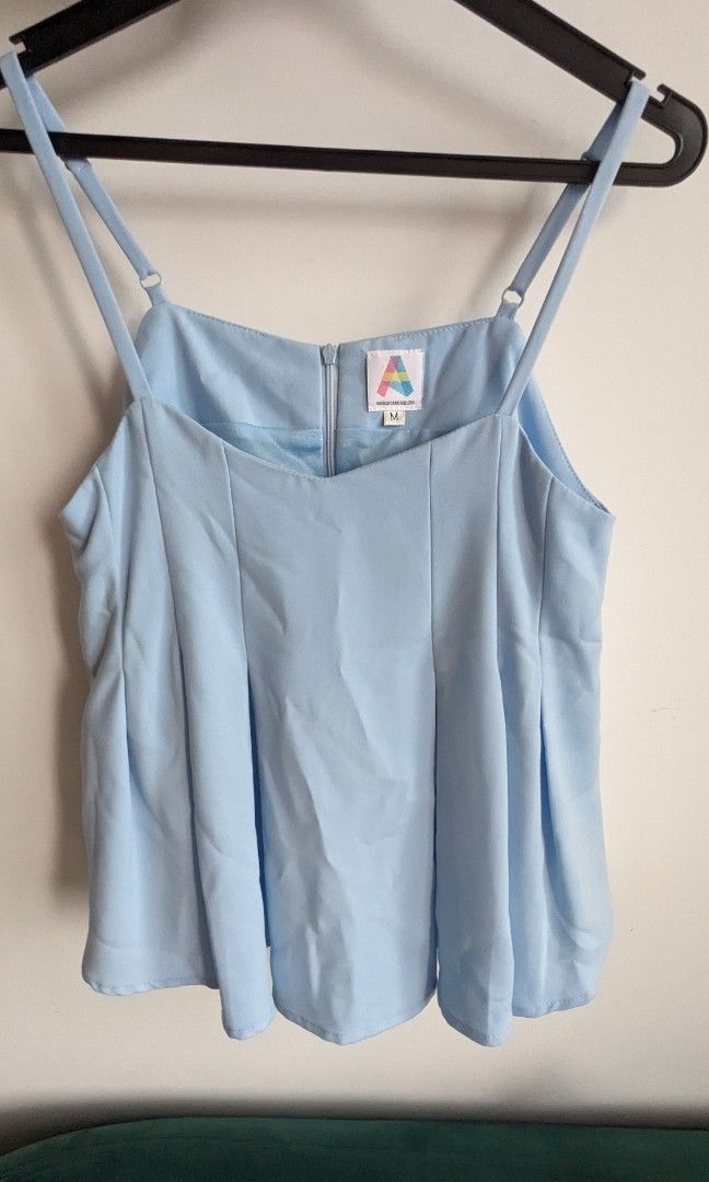 Basic spaghetti top (Category: Blouses) located in Singapore. Submitted by ferrls (Listing ID 1279049767, Image 1). Description: good condition, no signs of damage. shoulder straps are adjustable. there is an inner lining so not sheer. just need to iron before wearing and you're good to go..