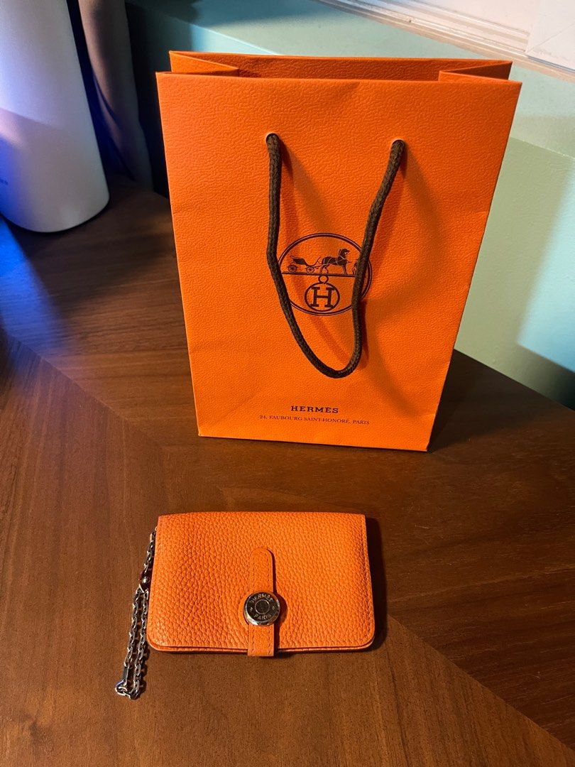 Hermes Dogon cardholder (Category: Luxury Bags & Wallets) located in Quezon City. Submitted by klosetmanila (Listing ID 1279606517, Image 1). Description: Classic H orange, clemence leather No box, with paper bag only Business card for size reference Has gussets on the side, accommodates lots of cards .