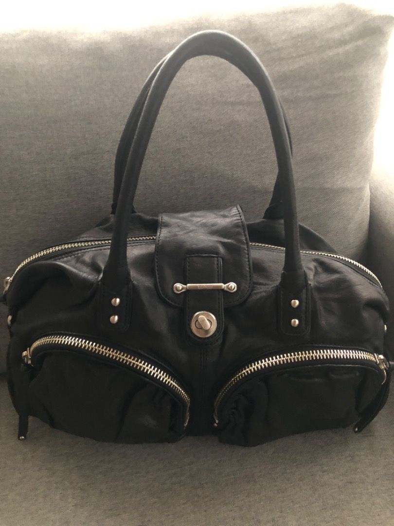 BOTKIER Bianca black leather satchel (Category: Luxury Bags & Wallets) located in Davao. Submitted by mliza1020 (Listing ID 1279835398, Image 1). Description: BOTKIER Bianca black leather satchel A Botkier double zip-pocket satchel in textured black leather. The design features dual shoulder straps, a center tab with a turn lock and top zipper closure, dual zippered pockets to the front and silver tone hardware throughout. The tan suede lining ha