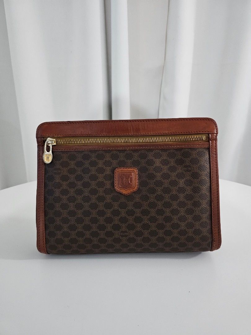 🧡Celine Macadam Brown Vintage Clutch (Category: Luxury Bags & Wallets) located in Las Pinas. Submitted by mybagsfromthepast (Listing ID 1280027013, Image 1). Description: 100% Original Celine Macadam Brown Vintage Clutch Unisex Clutch with wrist strap The perfect accessory to use to elevate your look. Brown PVC coated canvas with brown leather trim and brown leather handle. Top zipper closure with 1 interior zipper pocket. Very good preloved con