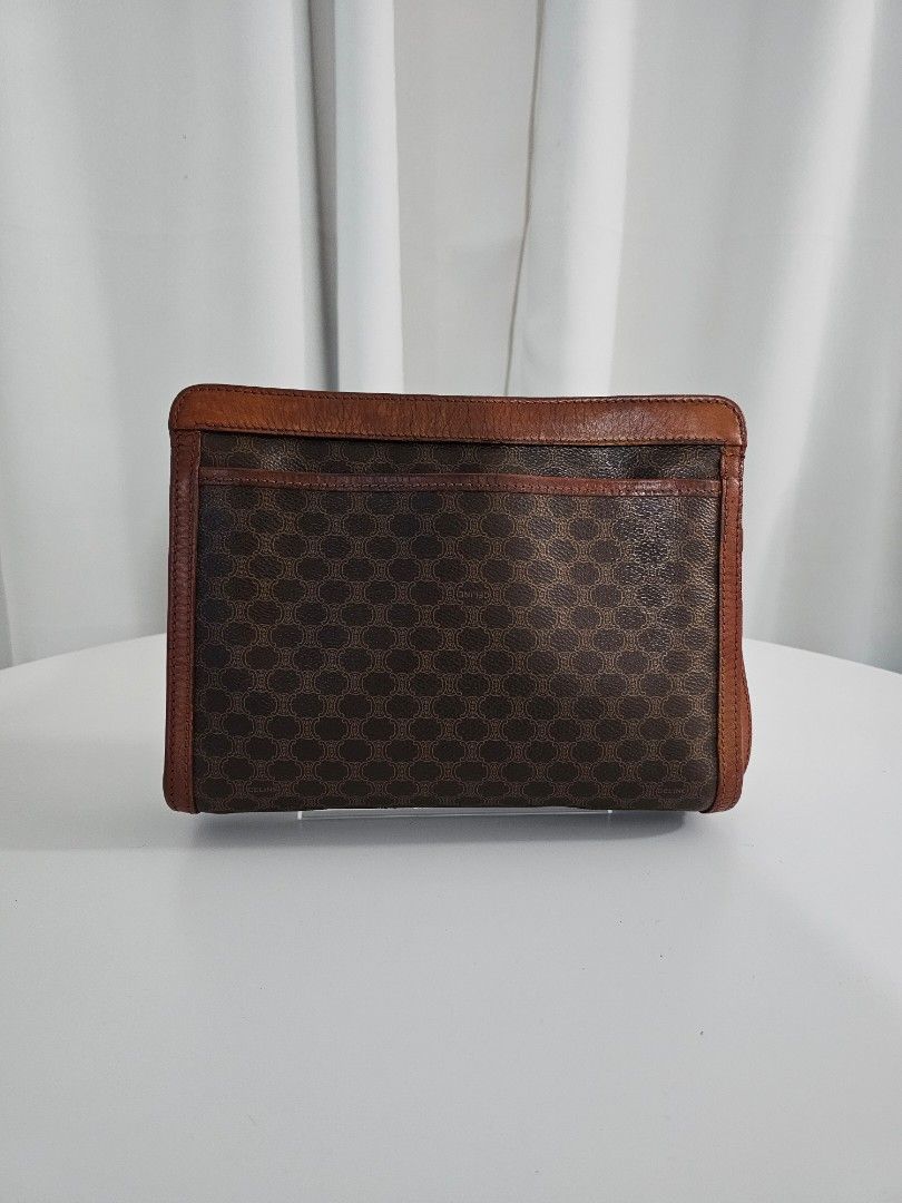 🧡Celine Macadam Brown Vintage Clutch (Category: Luxury Bags & Wallets) located in Las Pinas. Submitted by mybagsfromthepast (Listing ID 1280027013, Image 2). Description: 100% Original Celine Macadam Brown Vintage Clutch Unisex Clutch with wrist strap The perfect accessory to use to elevate your look. Brown PVC coated canvas with brown leather trim and brown leather handle. Top zipper closure with 1 interior zipper pocket. Very good preloved con